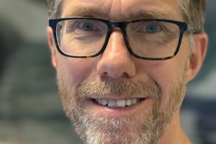 Lungespesialist Erik Dyb Liaaen Mann med briller, skjegg og kort hår. Blå skjorte.